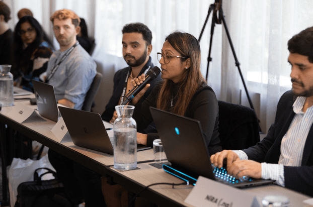 An attendee speaking during a model ICANN conference at APIGA Australia 2024.